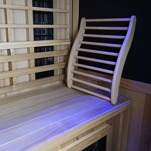 Inside infrared sauna view, showing bench and ergonomic adapter for lumber support.