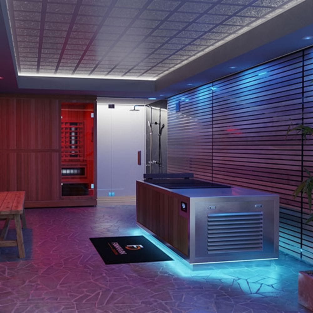 A modern indoor spa or wellness room featuring a large stainless steel and wood sauna/steam unit, a glass shower enclosure, a red sauna compartment, patterned flooring, and ambient blue and purple lighting.
