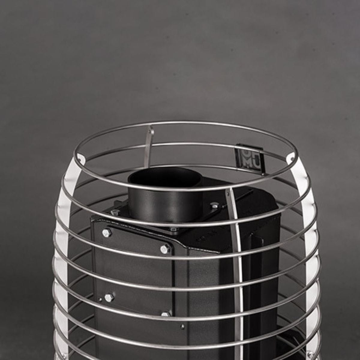 Black metal cylindrical object with wire cage on a dark background