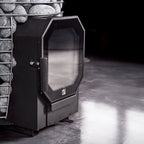 Black fireplace insert with glass door in a stone fireplace setting