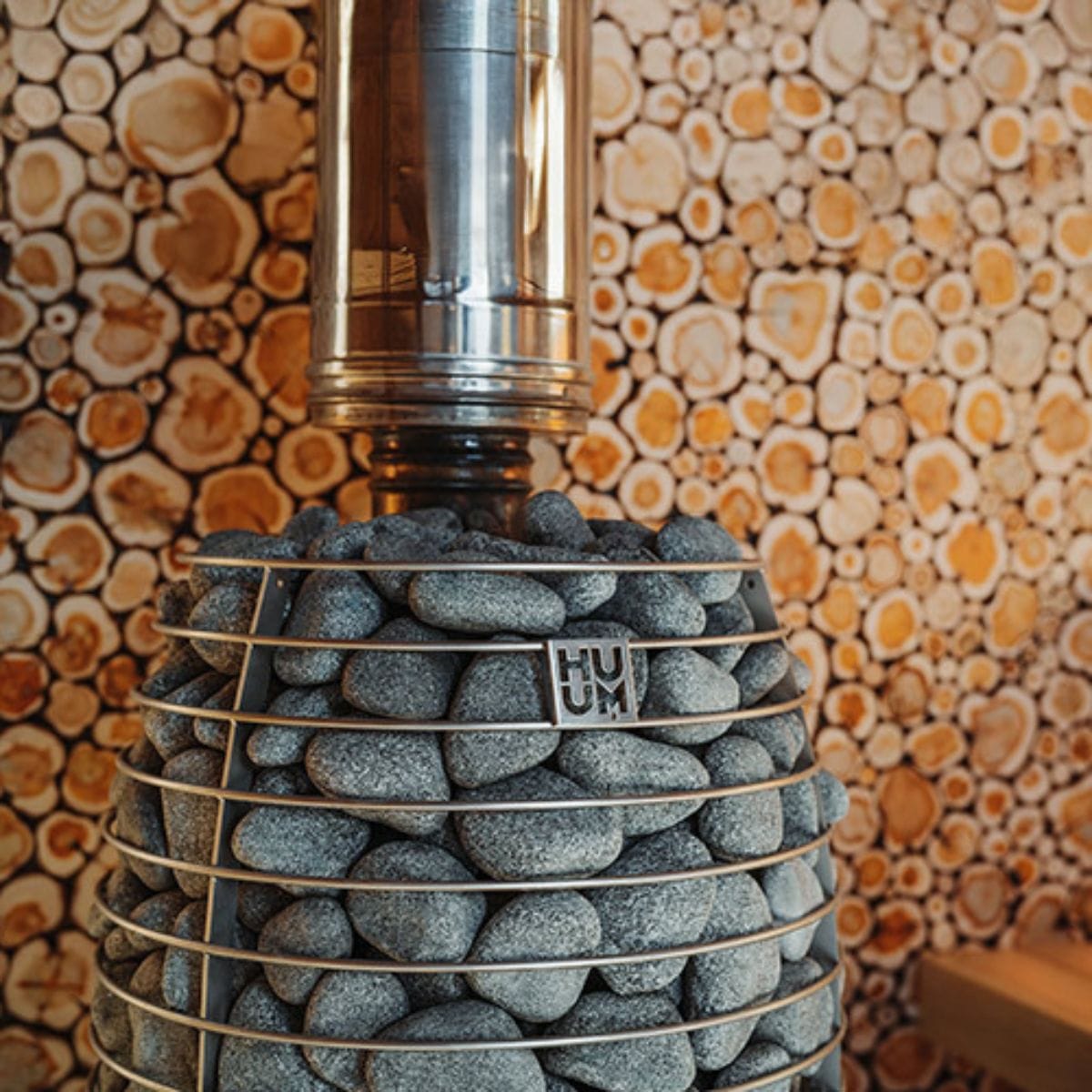 Decorative lamp with stone base and metallic top against a patterned wall.
