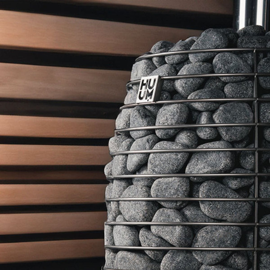 Decorative wall with stacked stones and 'HUUM' branding against a wooden slat background
