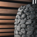 Decorative wall with stacked stones and 'HUUM' branding against a wooden slat background