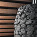 Decorative wall with stacked stones and 'HUUM' branding against a wooden slat background