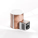 Wooden and metal cylindrical device with a fan on a white background