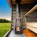 It features a glass door with a cast-iron frame, paired with adjustable legs and a comfortable wooden handle.&nbsp;