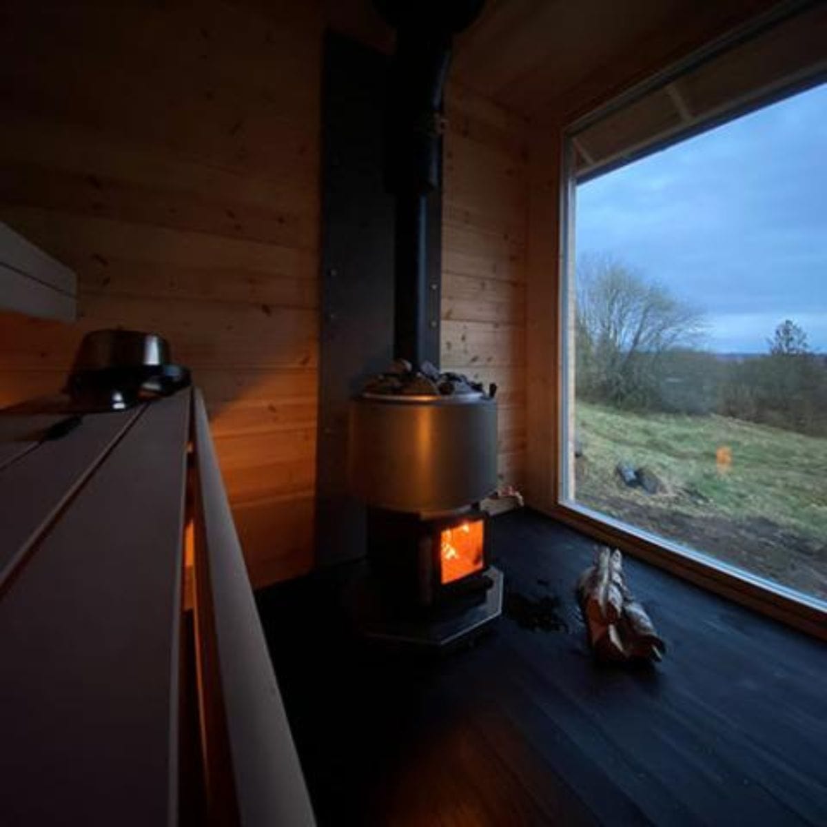 This sauna stove comes equipped with an integrated hot water tank and faucet.