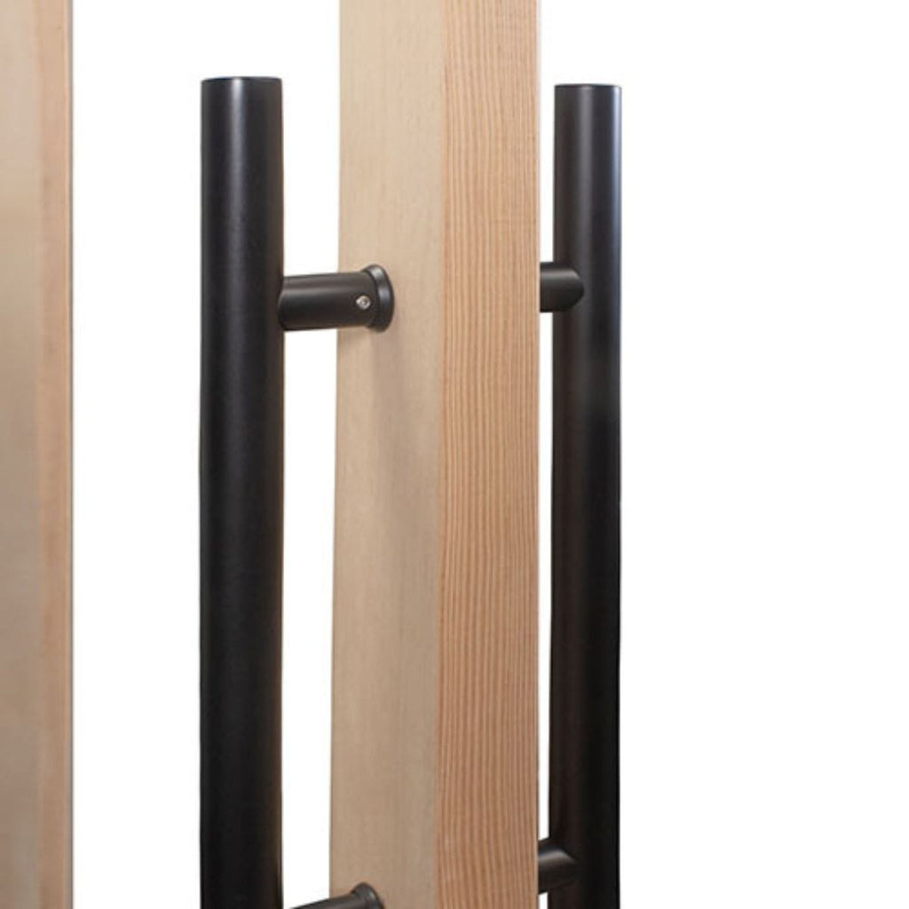 Close-up of a wooden door with black metal handles on a white background