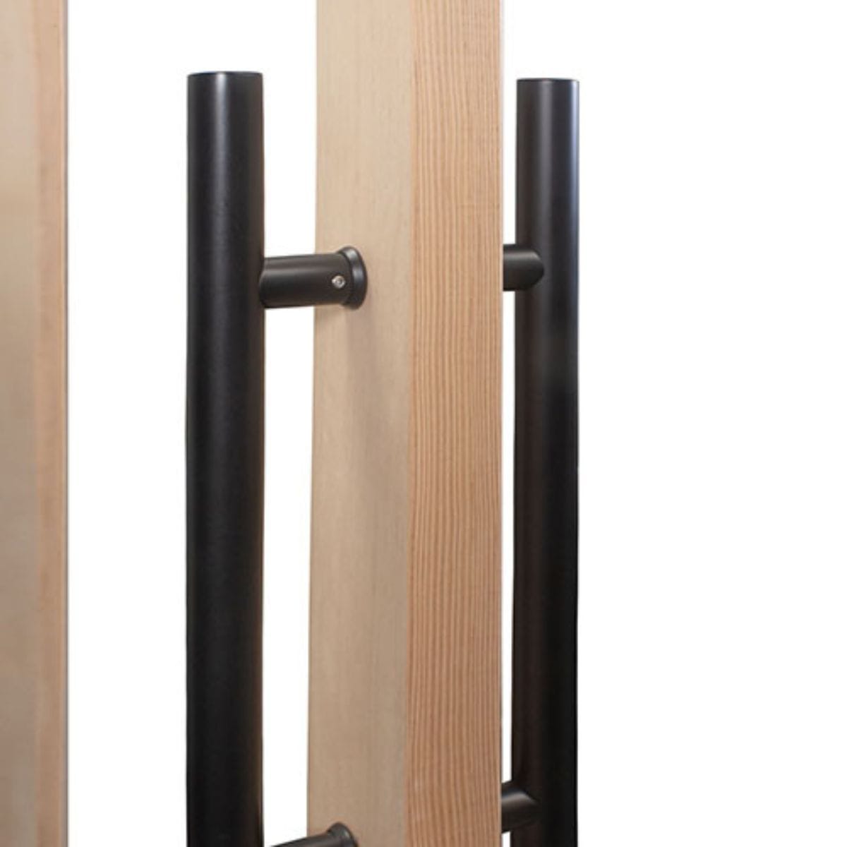 Close-up of a wooden door with black metal handles on a white background