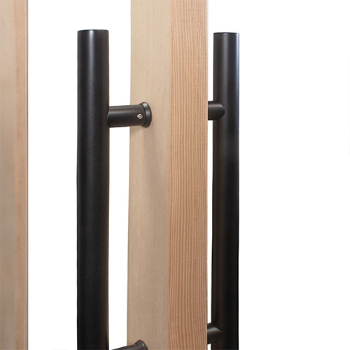 Close-up of black metal handles on wooden panels with a white background