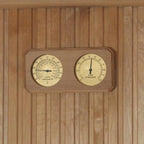 Wooden panel with a dual gauge thermometer and hygrometer on a wooden background