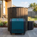 Blue outdoor refrigerator next to a wooden barrel on a patio
