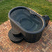 Portable hot tub on a brick patio with grass in the background