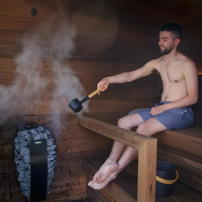 Man sitting in a sauna using a smoke machine